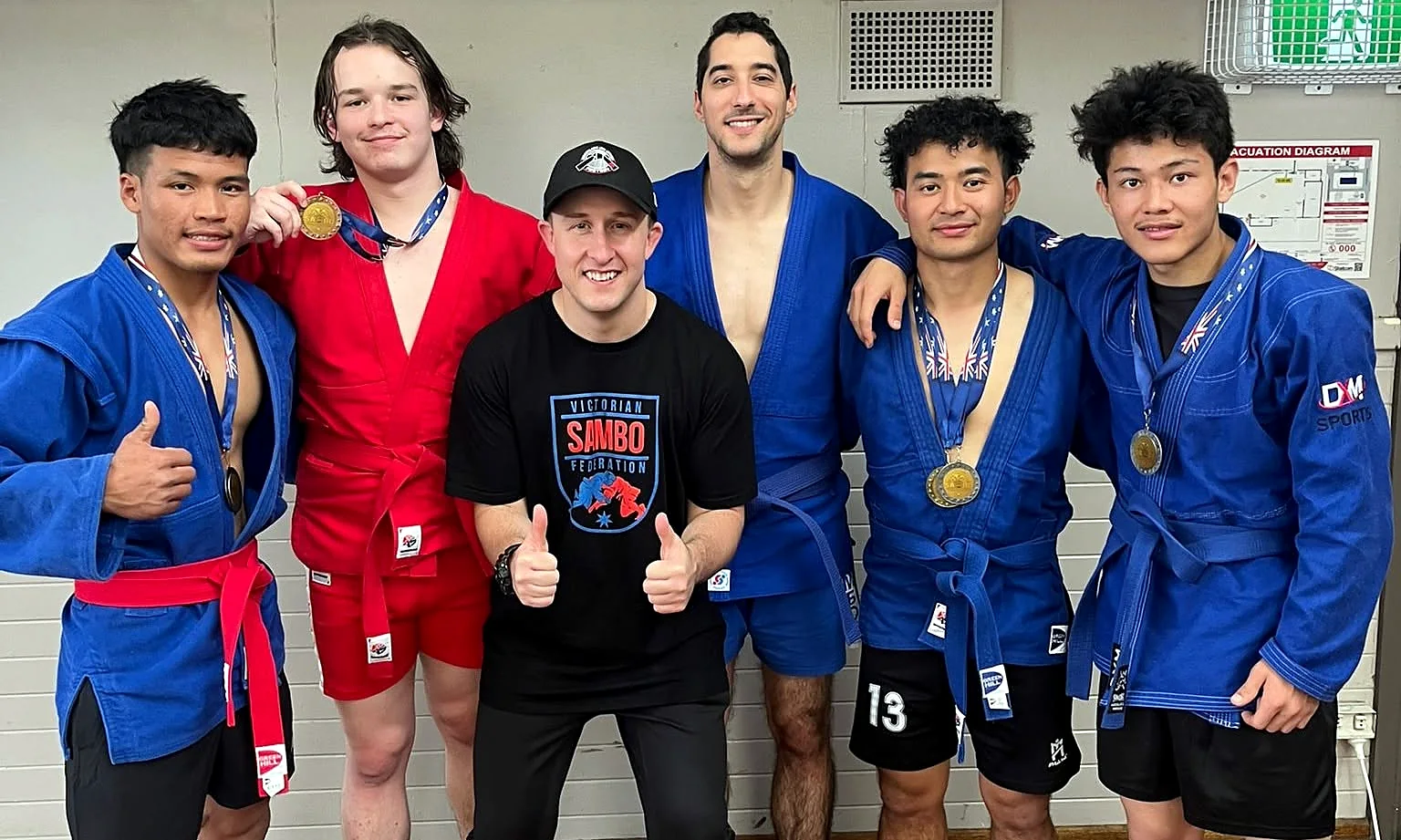 SAMBO competitors and coach with medals after state titles