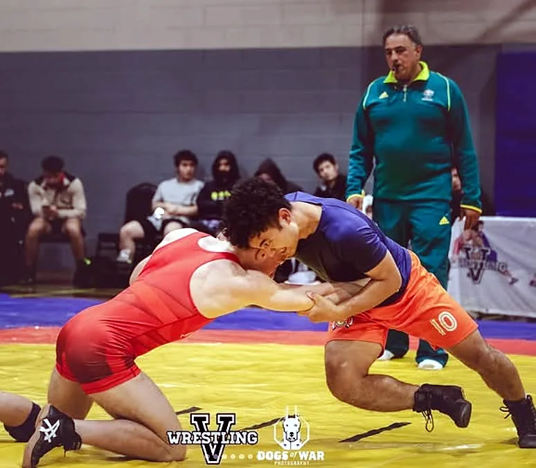 Wrestlers hand fighting and attacking a takedown during a match